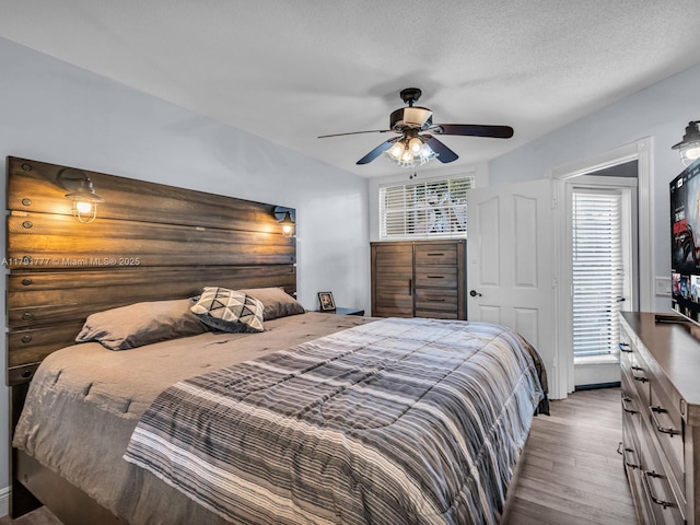 bedroom featuring a ceiling fan and wood finished floors