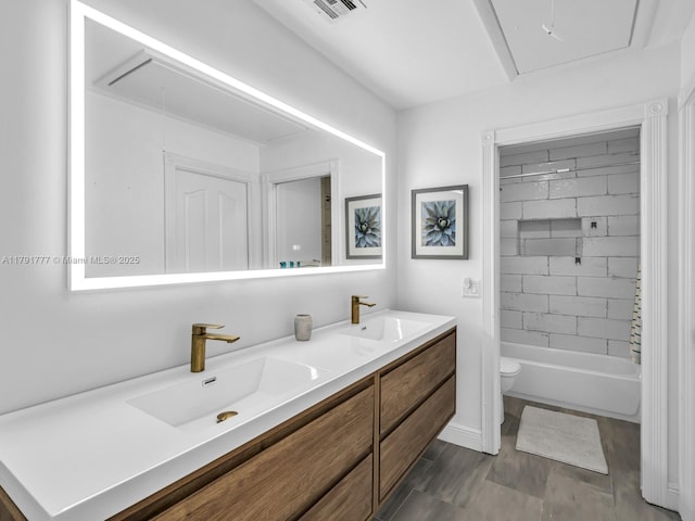 full bathroom featuring visible vents, a sink, double vanity, and toilet