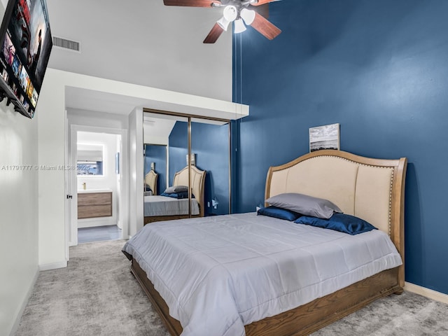 bedroom featuring ceiling fan, visible vents, carpet floors, baseboards, and connected bathroom