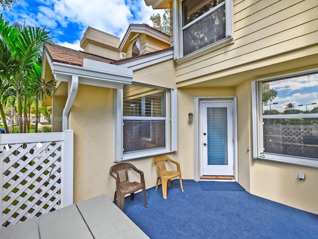 view of exterior entry with stucco siding