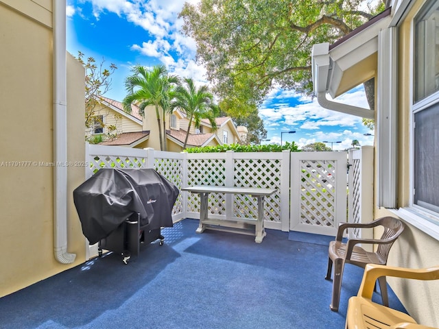 view of patio / terrace with grilling area, fence, and a gate