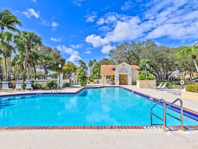 pool with fence and a patio area