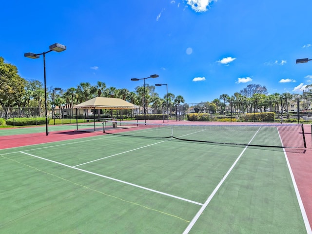 view of tennis court with fence and community basketball court