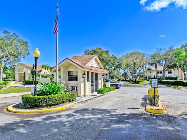 8109 Oakton Ct Unit 9D, Lake Clarke Shores, FL 33406 - view of asphalt road with curbs, street lights, and traffic signs