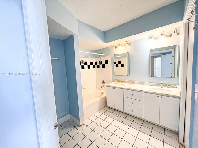 bathroom featuring double vanity, shower / tub combination, a sink, and tile patterned flooring