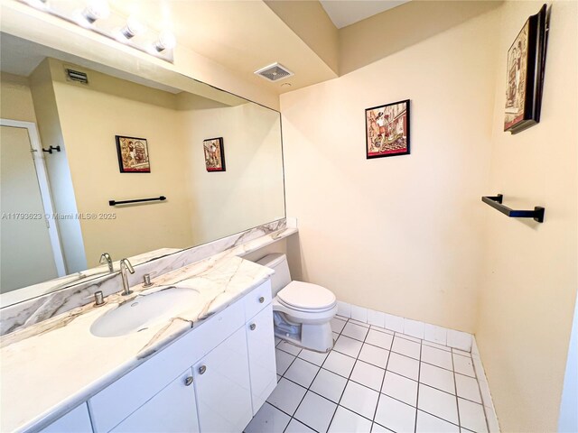 bathroom featuring vanity, tile patterned floors, visible vents, and toilet