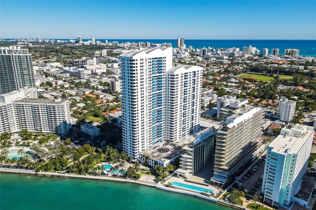 birds eye view of property featuring a water view and a city view