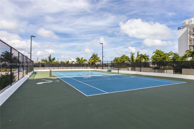 view of tennis court with fence