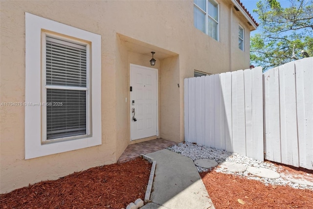 6813 Torch Key St, Lake Worth, FL 33467 - property entrance with fence and stucco siding