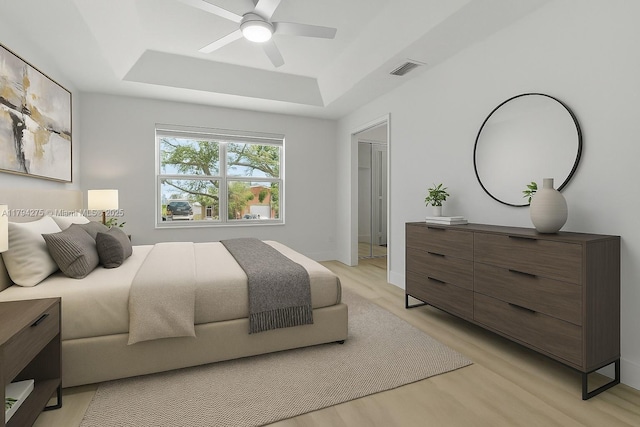 6813 Torch Key St, Lake Worth, FL 33467 - bedroom with visible vents, light wood-style floors, baseboards, a raised ceiling, and a ceiling fan