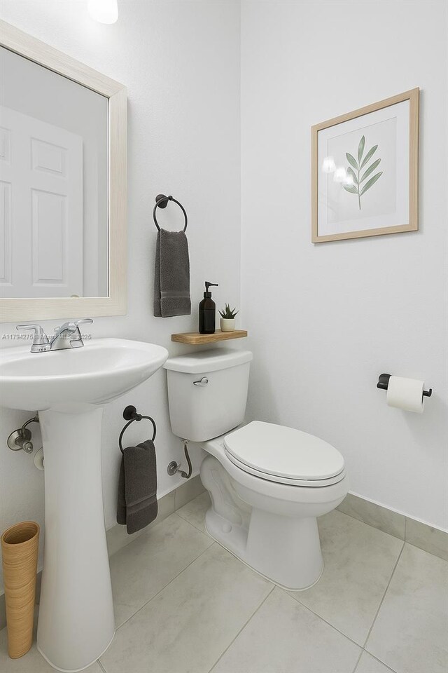 6813 Torch Key St, Lake Worth, FL 33467 - bathroom featuring baseboards, a sink, tile patterned floors, and toilet