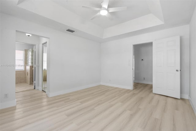 6813 Torch Key St, Lake Worth, FL 33467 - empty room with ceiling fan, baseboards, light wood-type flooring, a tray ceiling, and visible vents