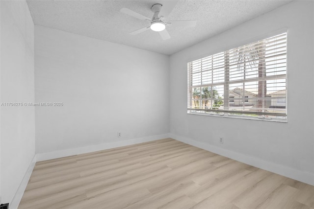 6813 Torch Key St, Lake Worth, FL 33467 - spare room featuring baseboards, a ceiling fan, a textured ceiling, and wood finished floors