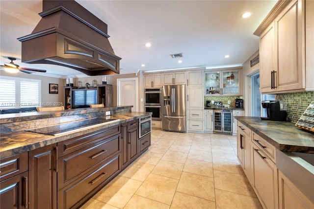 kitchen featuring wine cooler, glass insert cabinets, visible vents, stainless steel appliances, and tasteful backsplash