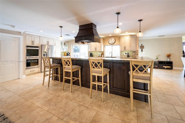 kitchen with recessed lighting, a kitchen bar, premium range hood, decorative backsplash, and stainless steel appliances
