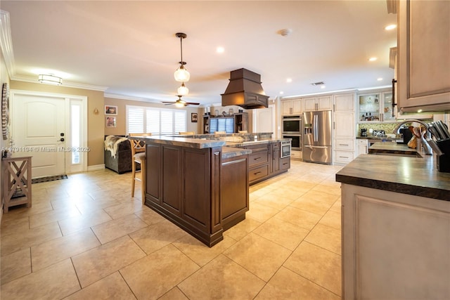 kitchen featuring ornamental molding, a sink, custom range hood, dark countertops, and stainless steel appliances
