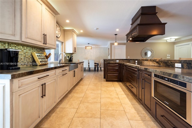 kitchen featuring premium range hood, black electric stovetop, oven, ornamental molding, and decorative backsplash
