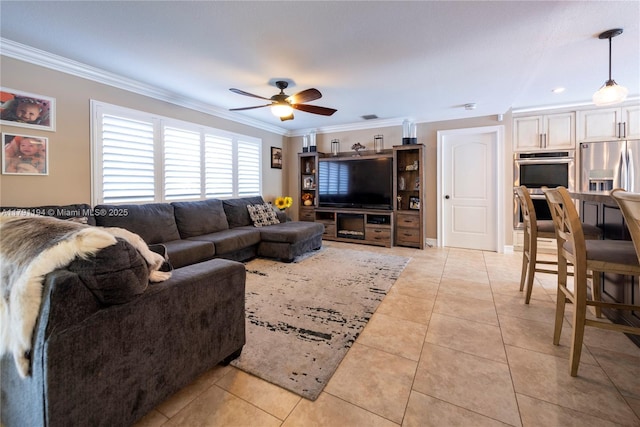 living room with light tile patterned flooring, crown molding, and a ceiling fan