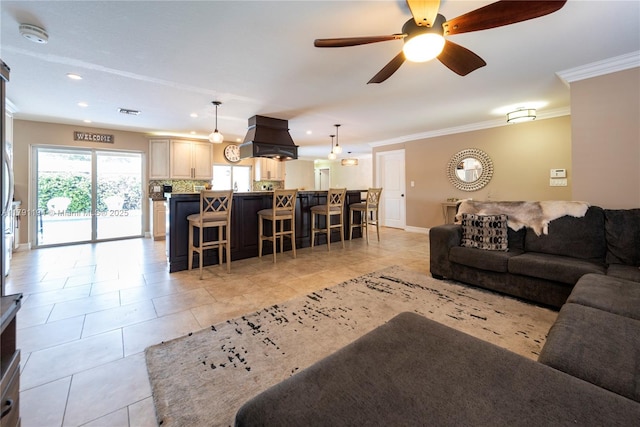 living room featuring a ceiling fan, recessed lighting, baseboards, ornamental molding, and light tile patterned flooring