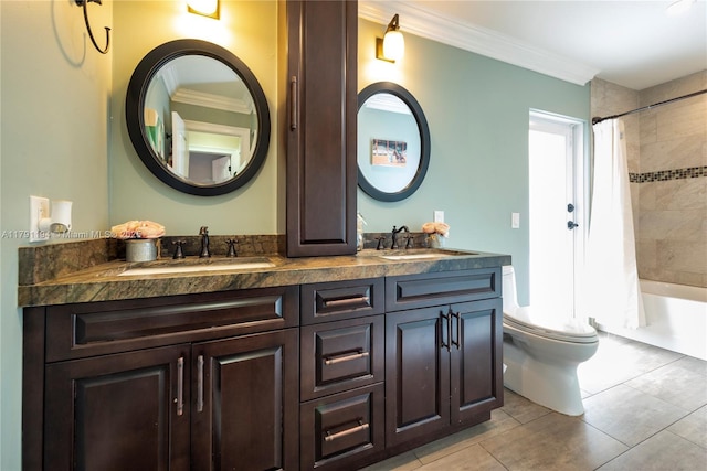 bathroom featuring a sink, crown molding, and toilet