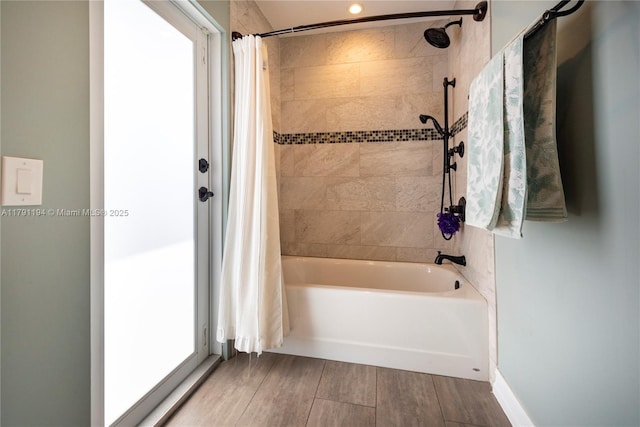 full bath featuring shower / bath combination with curtain and wood finished floors