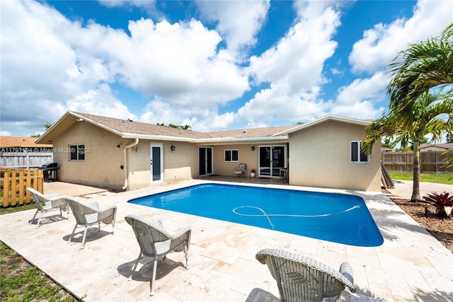 view of swimming pool with fence, area for grilling, a fenced in pool, and a patio area