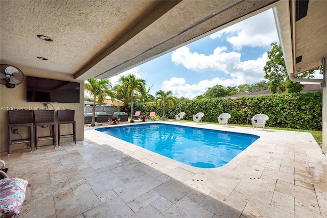view of swimming pool featuring a patio area, a fenced backyard, a fenced in pool, and an outdoor living space