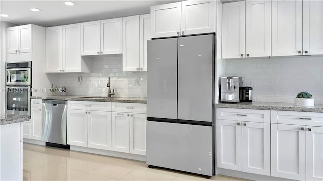 8195 SW 151st St, Palmetto Bay, FL 33158 - kitchen featuring white cabinets, stainless steel appliances, a sink, and tasteful backsplash