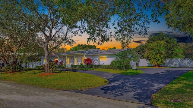 8195 SW 151st St, Palmetto Bay, FL 33158 - view of front of home featuring a lawn, fence, and curved driveway