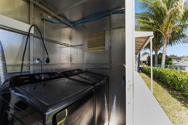 clothes washing area with laundry area and washer and clothes dryer