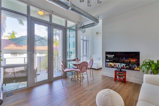 entryway featuring french doors, wood finished floors, and baseboards