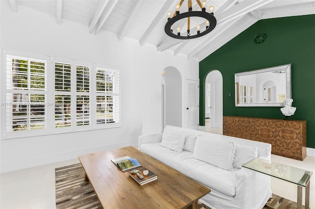 712 NE 72nd St, Miami, FL 33138 - living room featuring beamed ceiling, arched walkways, high vaulted ceiling, and a chandelier