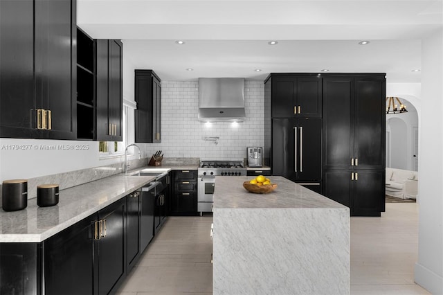 712 NE 72nd St, Miami, FL 33138 - kitchen featuring wall chimney range hood, dark cabinetry, high quality appliances, and a sink