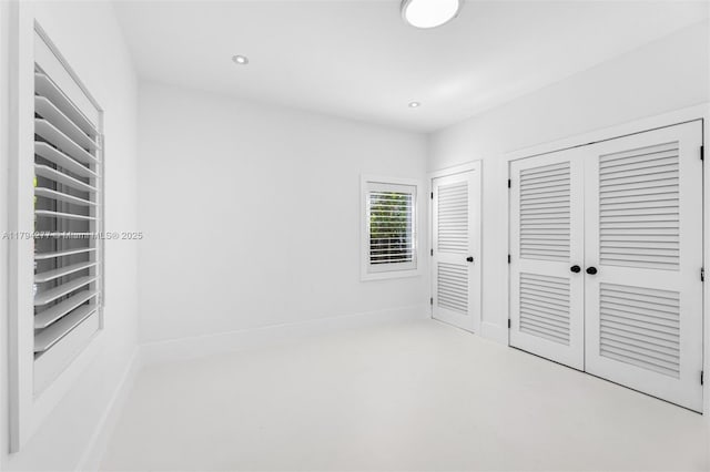 712 NE 72nd St, Miami, FL 33138 - unfurnished bedroom with two closets, recessed lighting, and concrete floors
