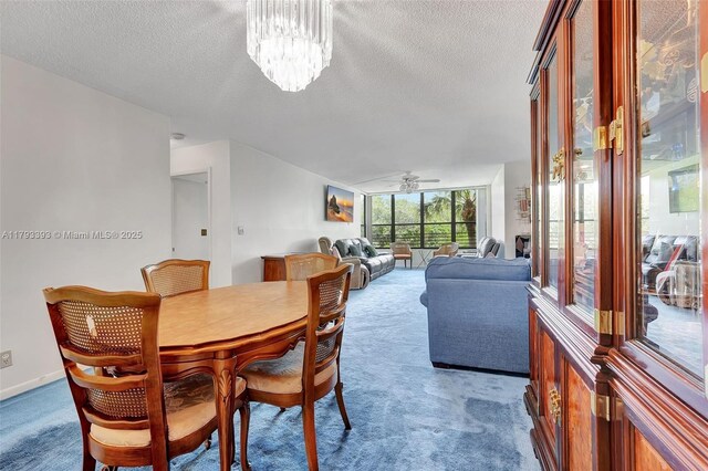 dining area featuring carpet floors, a textured ceiling, and ceiling fan with notable chandelier