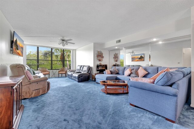 carpeted living room featuring a ceiling fan, floor to ceiling windows, visible vents, and plenty of natural light