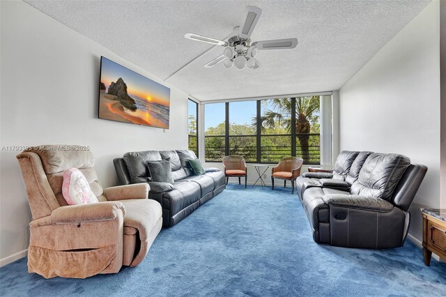 living room featuring a ceiling fan, a textured ceiling, floor to ceiling windows, and carpet