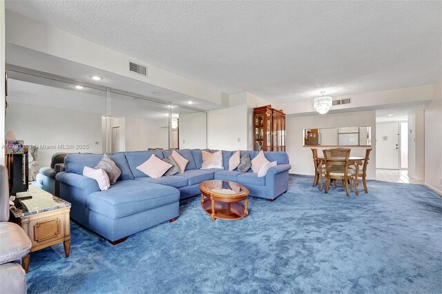 living area featuring visible vents, recessed lighting, carpet, and a textured ceiling