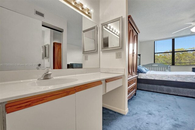 bathroom with visible vents, a ceiling fan, and vanity