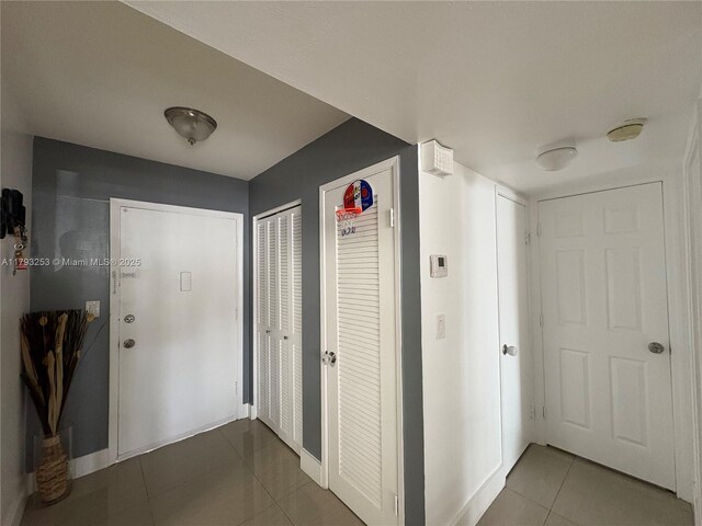 1680 NE 191st St Unit 118-2, Miami, FL 33179 - hallway with baseboards and tile patterned flooring