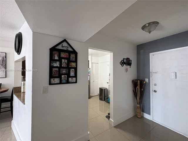 1680 NE 191st St Unit 118-2, Miami, FL 33179 - foyer entrance with baseboards and light tile patterned flooring