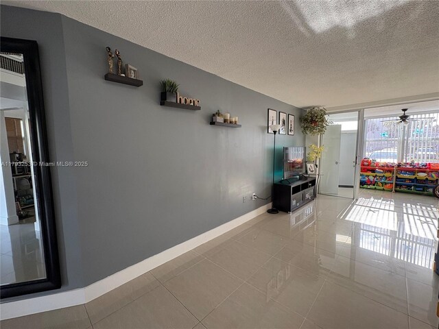 1680 NE 191st St Unit 118-2, Miami, FL 33179 - hall featuring baseboards, a textured ceiling, and light tile patterned floors