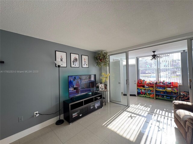 1680 NE 191st St Unit 118-2, Miami, FL 33179 - tiled living room featuring a ceiling fan, a textured ceiling, and baseboards