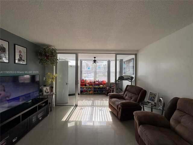 1680 NE 191st St Unit 118-2, Miami, FL 33179 - living room featuring a textured ceiling and tile patterned flooring
