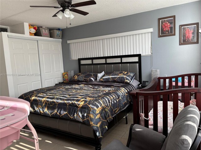 1680 NE 191st St Unit 118-2, Miami, FL 33179 - bedroom featuring a ceiling fan, a textured ceiling, tile patterned floors, and a closet