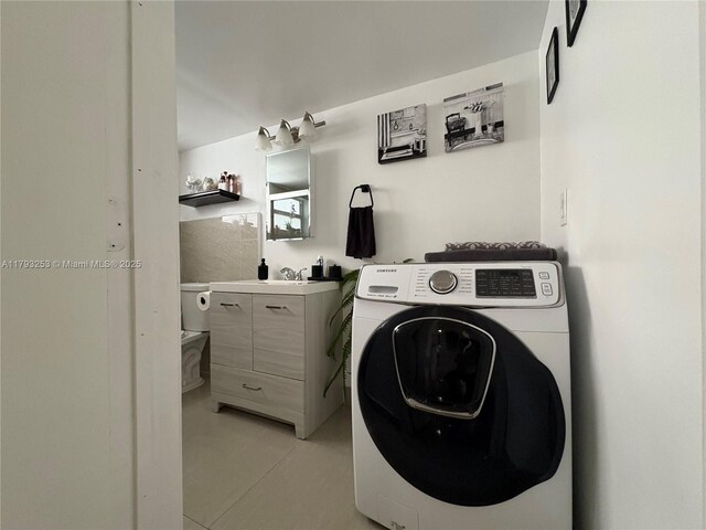 1680 NE 191st St Unit 118-2, Miami, FL 33179 - washroom featuring laundry area, washer / clothes dryer, and light tile patterned floors
