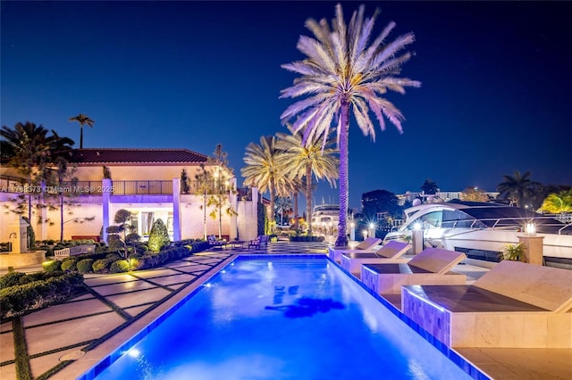 600 Isle Of Palms Dr, Fort Lauderdale, FL 33301 - pool at twilight featuring a community pool and a patio area