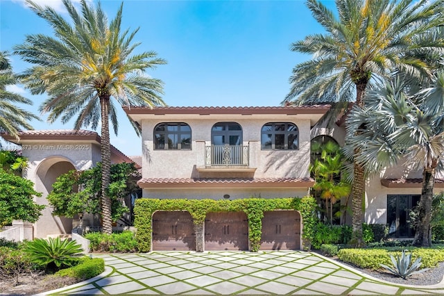 600 Isle Of Palms Dr, Fort Lauderdale, FL 33301 - view of front of home with a garage, stucco siding, a tiled roof, and a balcony