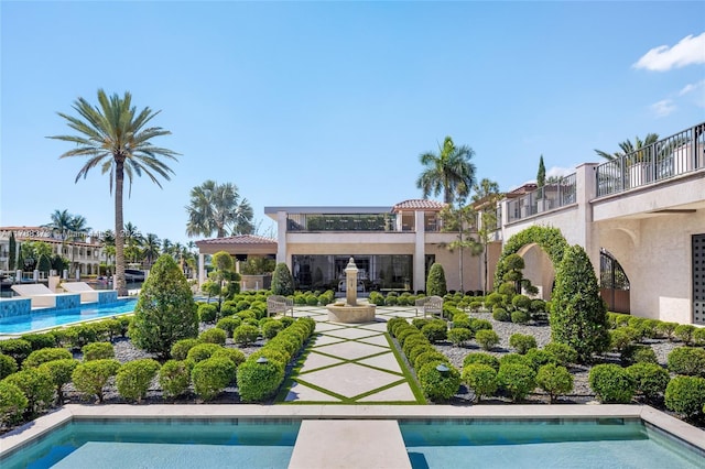 600 Isle Of Palms Dr, Fort Lauderdale, FL 33301 - rear view of house featuring stucco siding, a tiled roof, and an outdoor pool