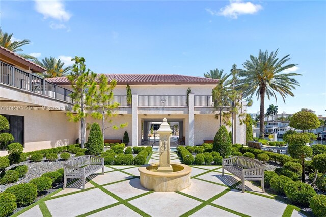 600 Isle Of Palms Dr, Fort Lauderdale, FL 33301 - exterior space featuring a patio area, a balcony, stucco siding, and a tiled roof